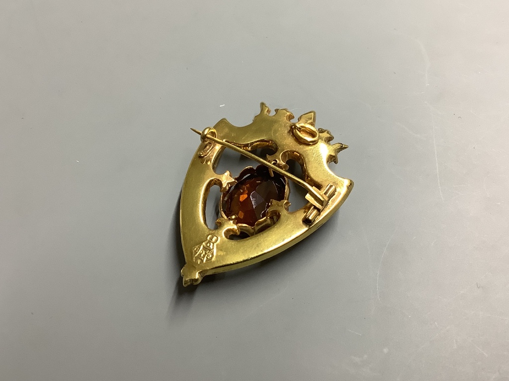 A late Victorian 15 carat gold citrine, seed pearl, cabochon and Scottish hardstone set shield brooch, 46 mm, gross 9.9 g.